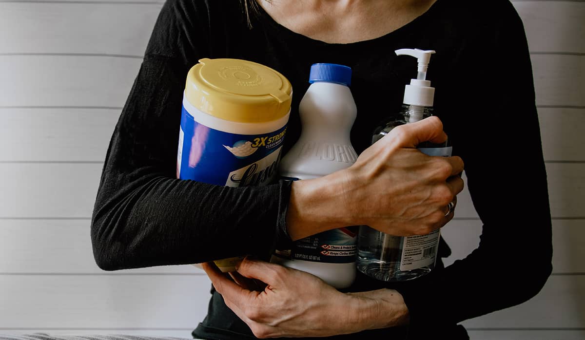 cleaning the house. an image showing a female holding cleaning supplies