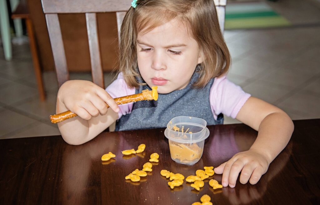 gold fishing - an edible busy bag with goldfish crackers, pretzel sticks and peanut butter.